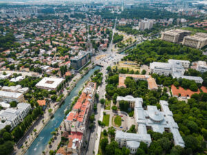 Aerial drone view of Bucharest, Romania. City downtown with water channel, greenery and multiple buildings