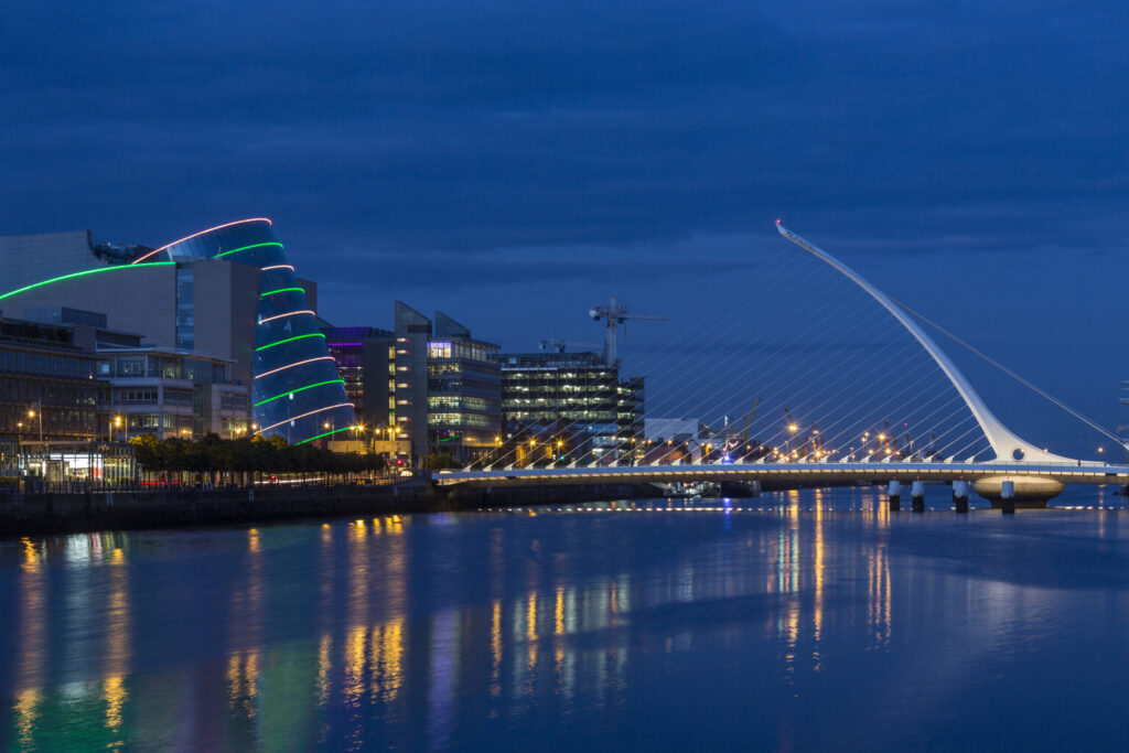 The River Liffey, the Samuel Beckett Bridge and the building on the waterfront near the Convention Center - Dublin city center in the republic of Ireland.