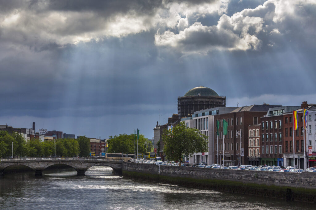 Storm clouds and sunrays over the River Liffey and the city of Dublin in the Republic of Ireland.