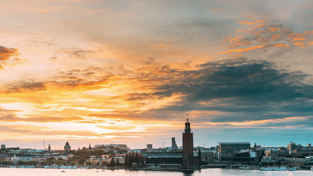 Stockholm, Sweden. Skyline Cityscape Famous View Of Old Town Gamla Stan In Summer Evening. Famous Popular Destination Scenic UNESCO World Heritage Site. Popular City Hall, Riddarholm Church In Sunset