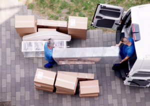 Furniture removals background – image showing professional movers handling furniture for relocation