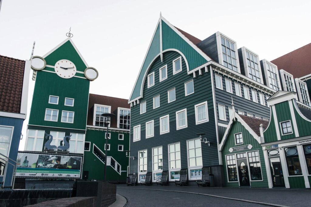 Traditional Dutch green wooden houses in a Dutch town, showcasing the destination for UK-to-Netherlands movers.