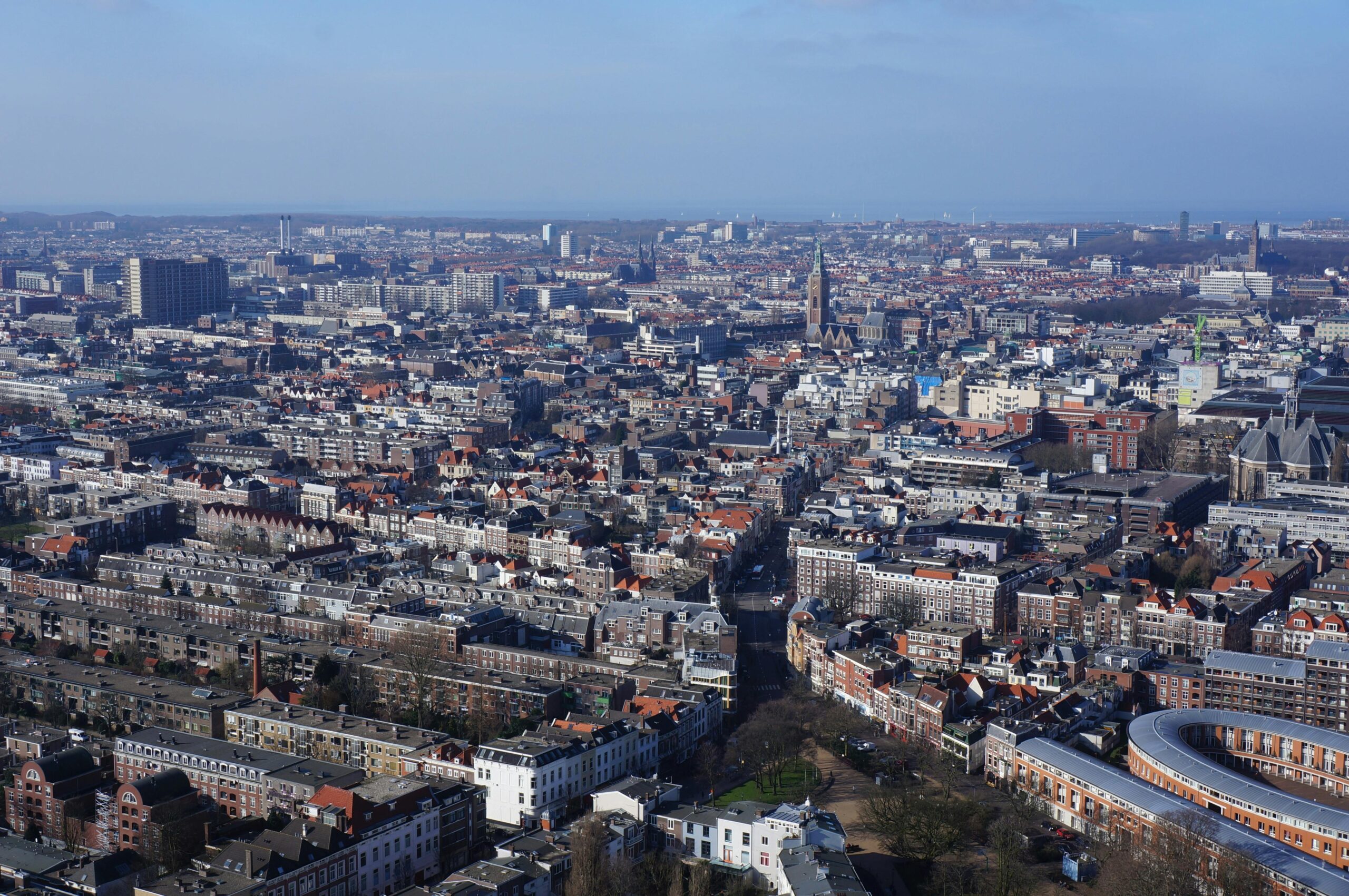 Aerial view of a densely built Dutch city showcasing organized urban planning and historic architecture, illustrating urban life in the Netherlands for the "living in Austria vs Netherlands" comparison.