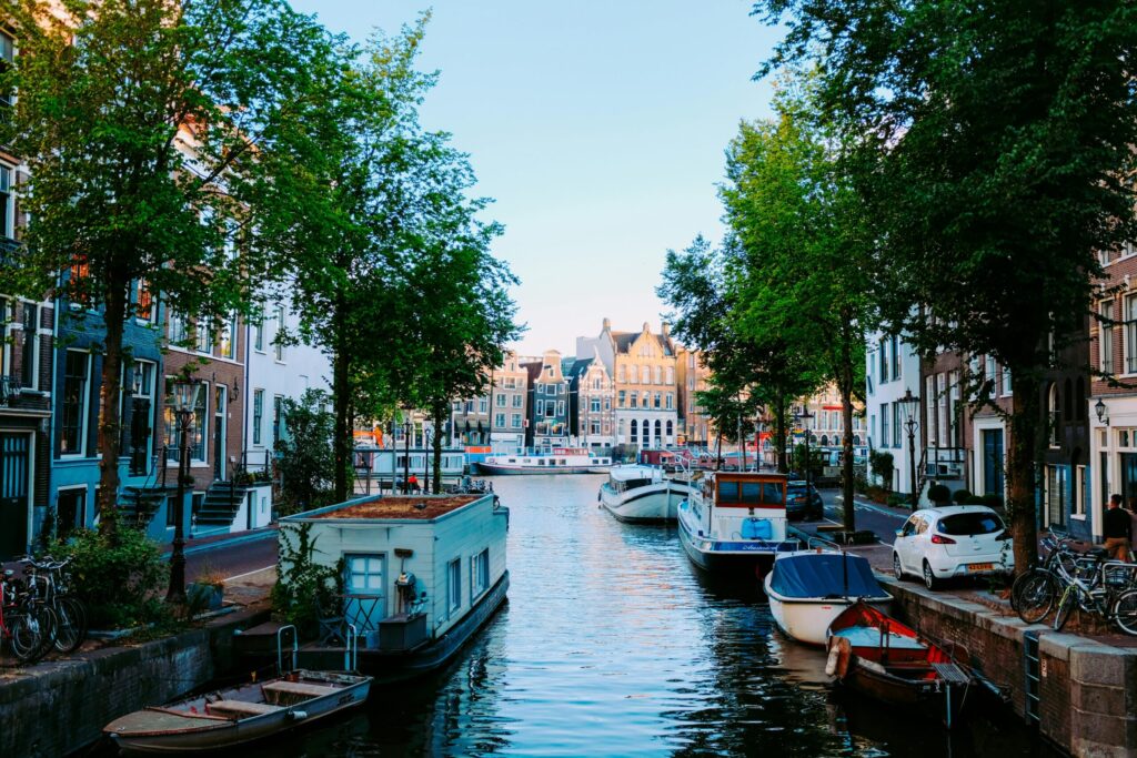 Picturesque canal in the Netherlands with boats and historic houses—visual contrast for lifestyle in the "living in Netherlands vs UK" comparison.