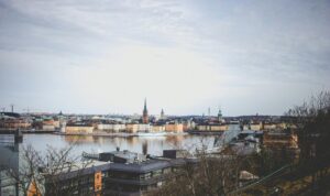 Panoramic view of a European waterfront city with historic church spires, ideal for illustrating European relocations and international removals with VANonsite.