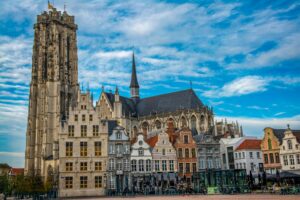 Saint Rumbold's Cathedral and historic guild houses on the main square in Mechelen Belgium, shown as a destination for people moving to Belgium with VANonsite European removals