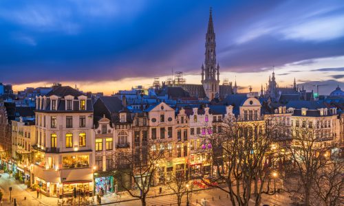 Brussels, Belgium plaza and skyline with the Town Hall tower at dusk.
