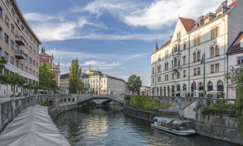 Buildings and pedestrian bridge over urban canal, Ljubljana, Central Slovenia, Slovenia